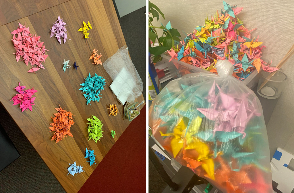 Two photos of many brightly colored cranes made out of post-its. In the first photo, the cranes are sorted into piles by color. In the second photo, the cranes are gathered in a bin and a plastic bag.