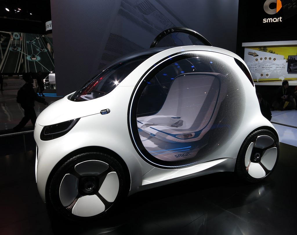 A futuristic small white car with a circular door that is transparent, looking like it’s made out of glass with two seats inside.