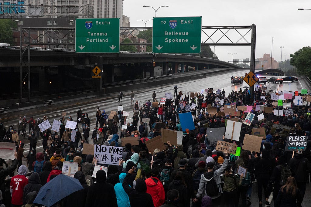 Demonstrators shut down Interstate 5 and march along the freeway during protests. (Matt M. McKnight/Crosscut)