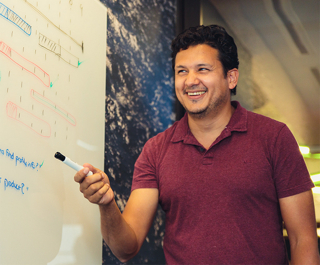 Our founder, Beto Gallardo, writing on a whiteboard.