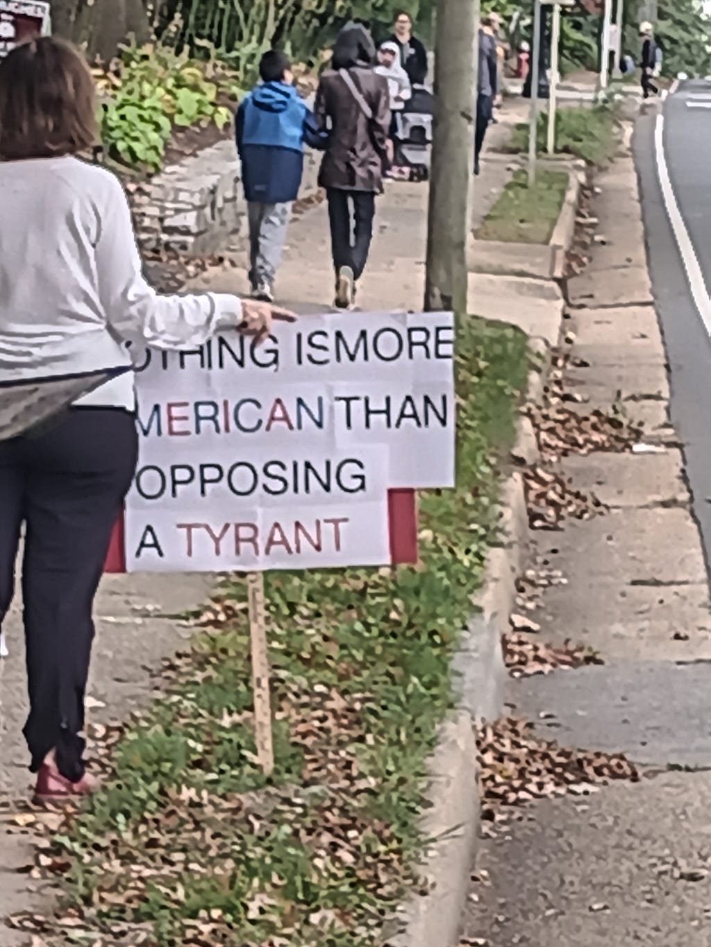 protest sign says Nothing is more American than opposing a tyrant