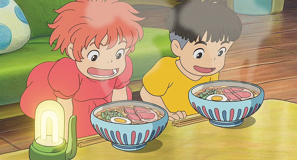 The main characters of Ponyo, a little girl and a little boy, stare excitedly at their two bowls of delicious ramen.