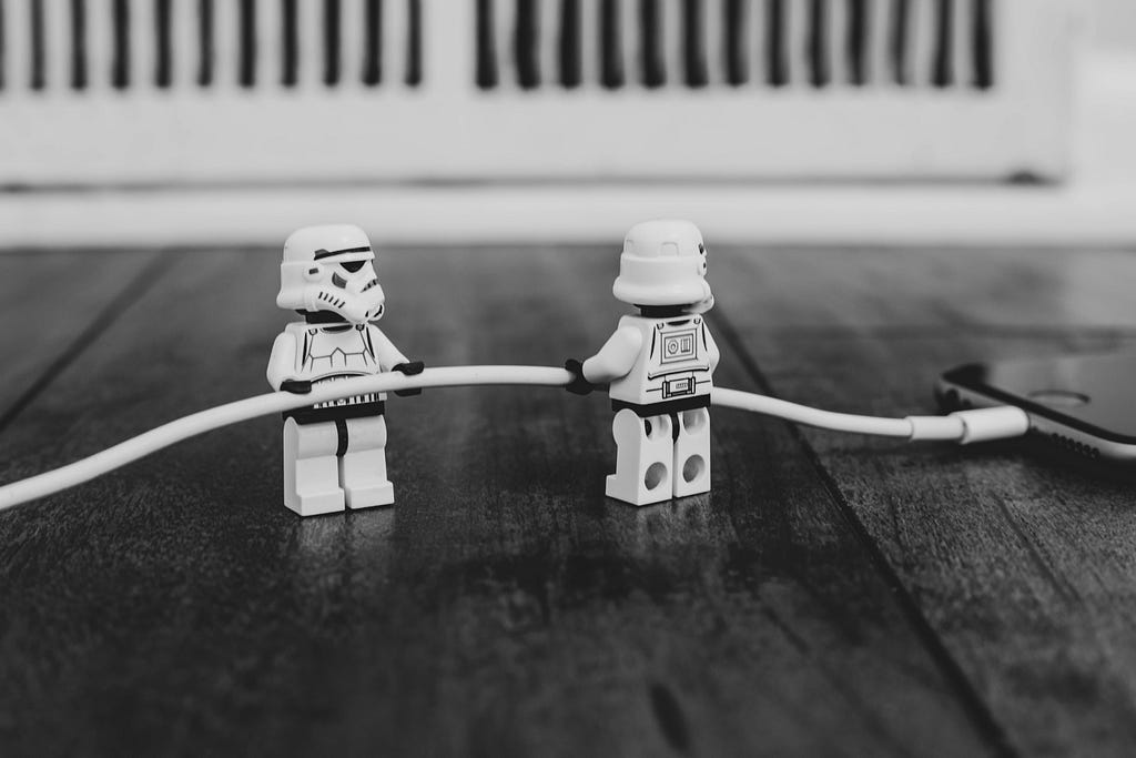 Storm troopers collaborating to charge an iPhone