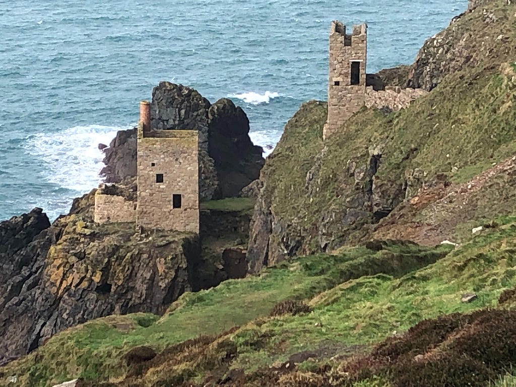 A crumbling tower stands on the Cornish coastline