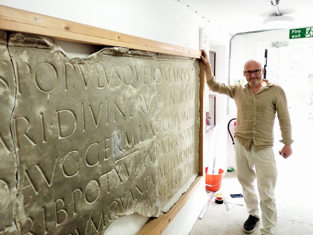 Mark Brooks, Lettering Artist and Stonemason at Artisan Memorials. Photo taken by Antonello Mirone, at the Trajan Column cast in City & Guilds London School of Art.