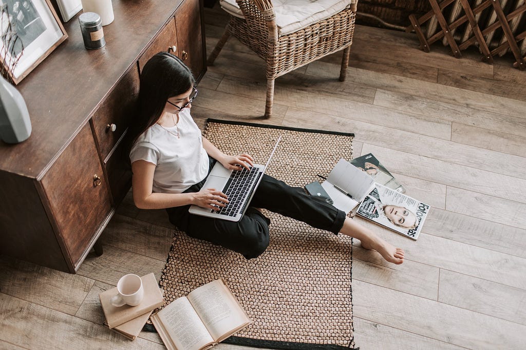 brand journalist on laptop sitting on floor