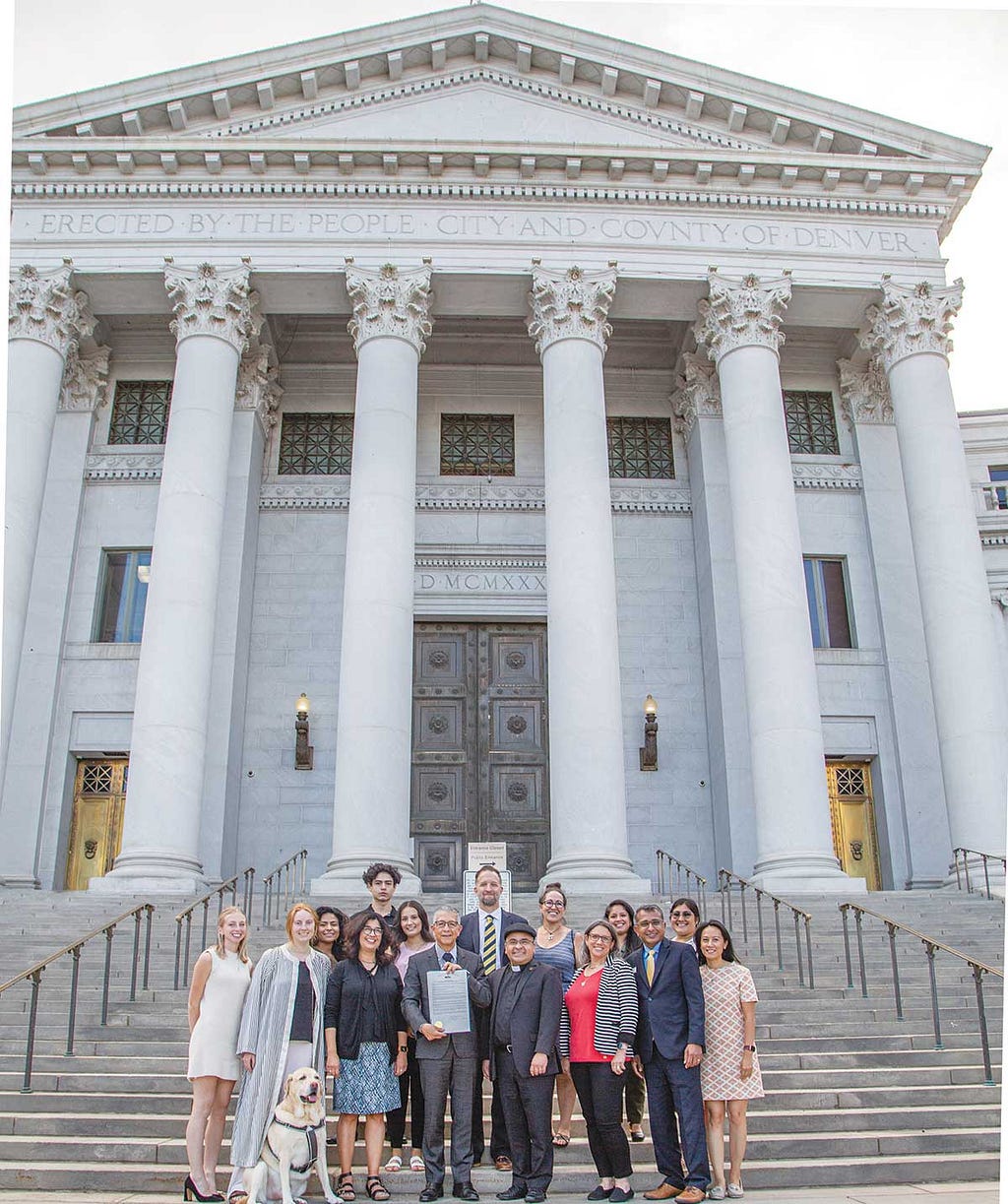 President Salvador Aceves, students, faculty and staff pose for a photo in front of the Denver City Council building after being awarded a proclamation recognizing the University’s status as a Hispanic Serving Institution in Denver Colorado