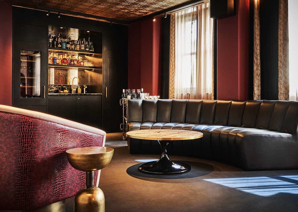 The York Apartment, a view of the bar, custom sofa and faux snakeskin chair. Photo courtesy of Chateau Denmark. Story by Laura Metze.