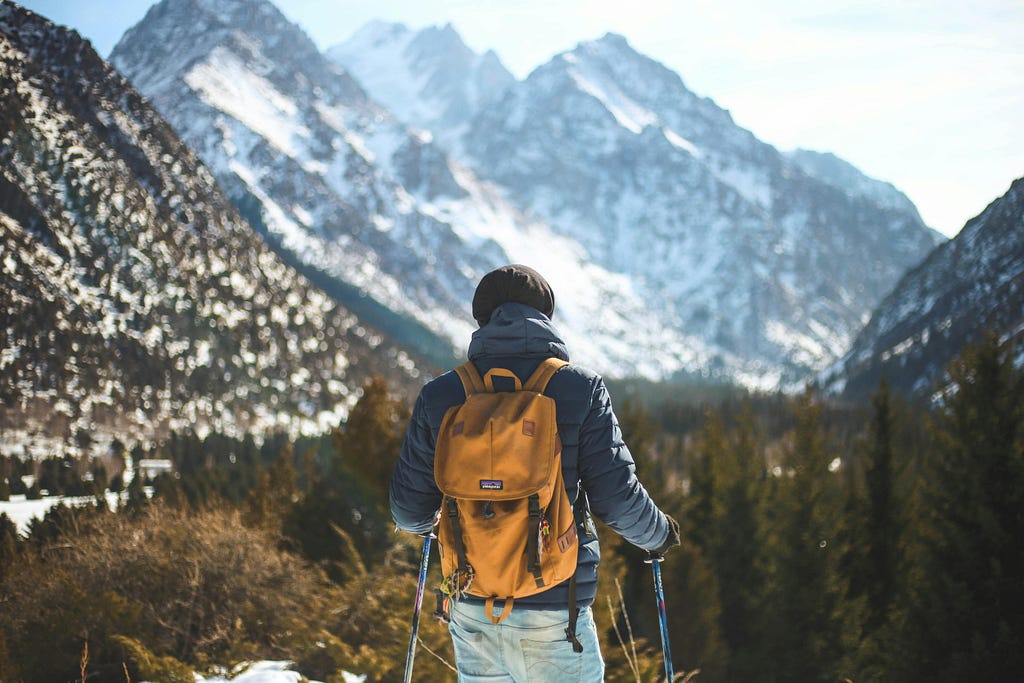 Man with backpack standing in the mountains