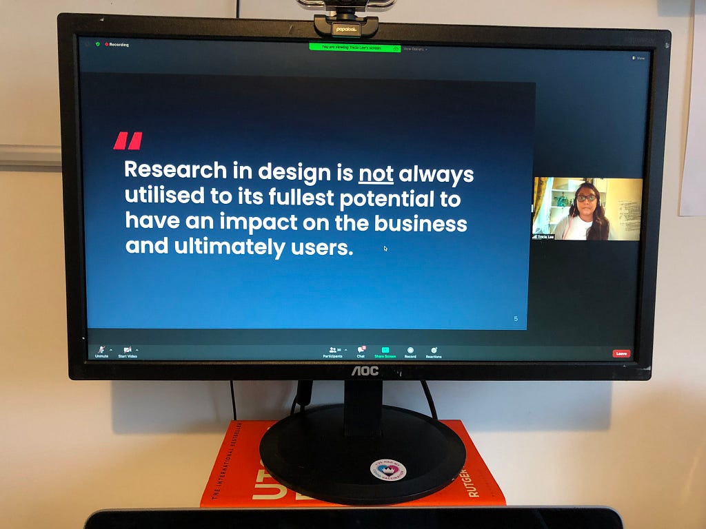 A photo of me on a computer screen, me giving my very first public talk in UX since joining the corporate world.