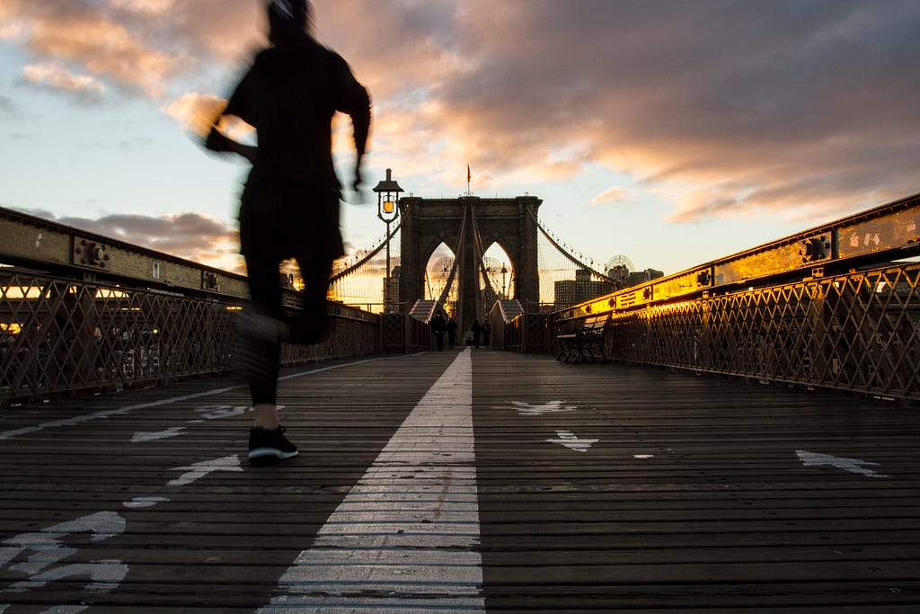 Running on the Brooklyn Bridge at sunrise