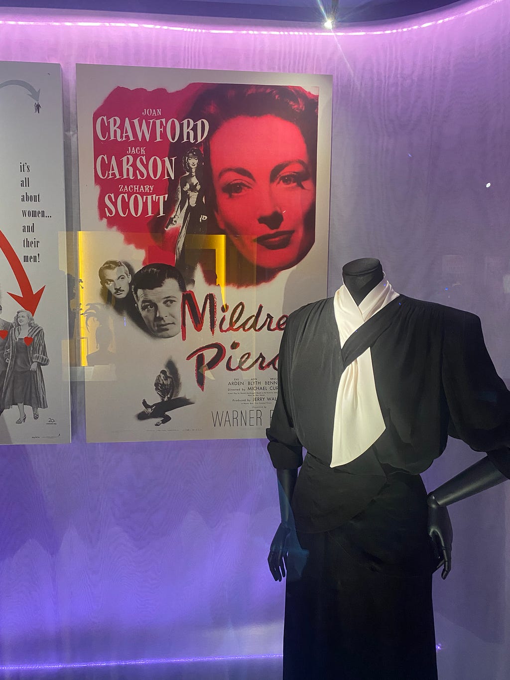 Mildred Pierce film poster and padded power suit worn by Joan Crawford in the film in 1945