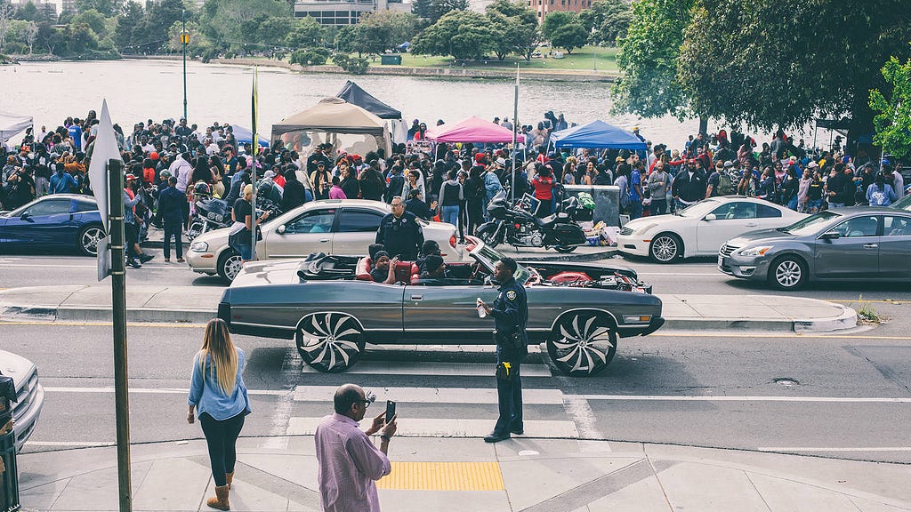 Scraper drives by crowd at Lake Merrit during creative protest, BBQ’n While Black