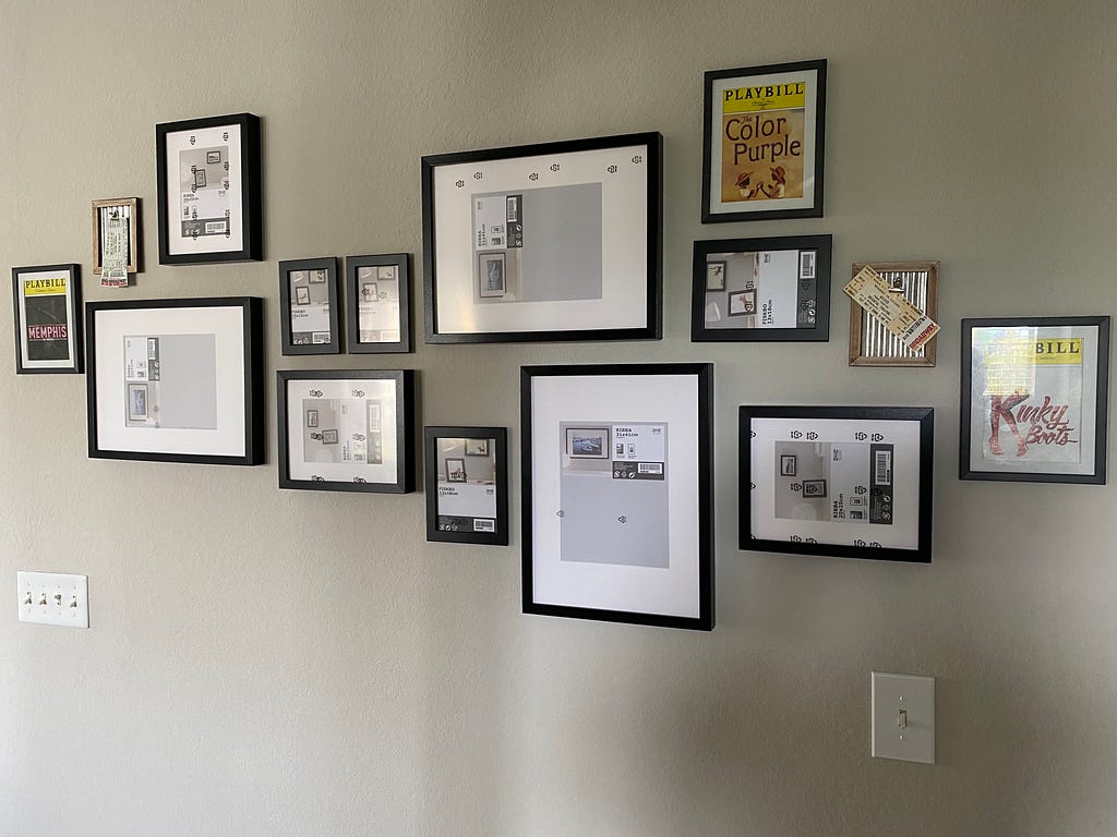 A wall full of different size photo frames.
