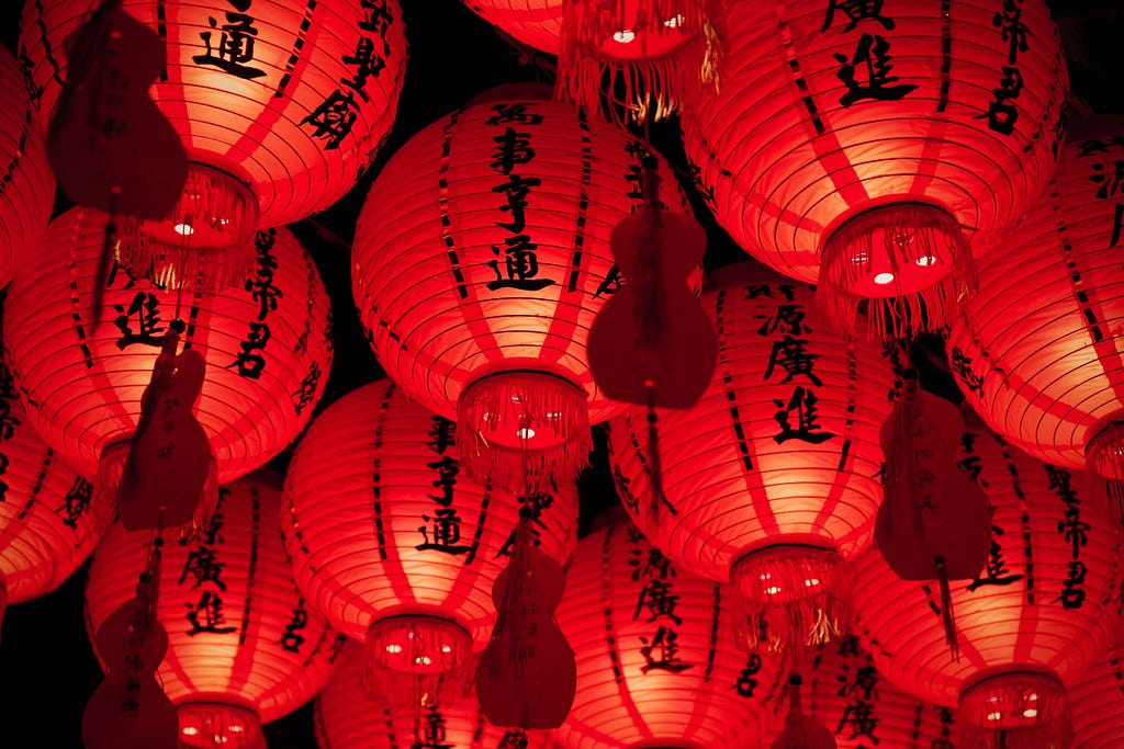 Group of red Chinese lanterns hanging from the ceiling
