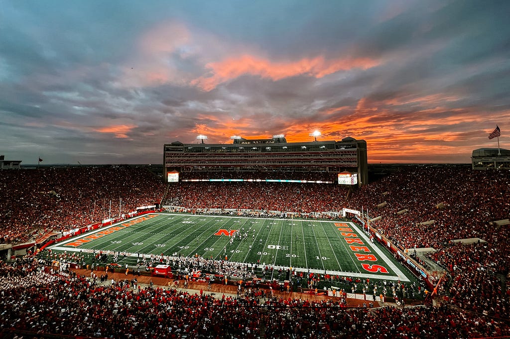 The sun sets during a sold-out Husker Football game