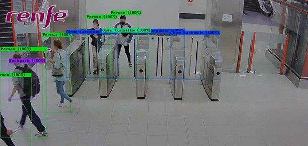 People passing through security terminals in a subway station