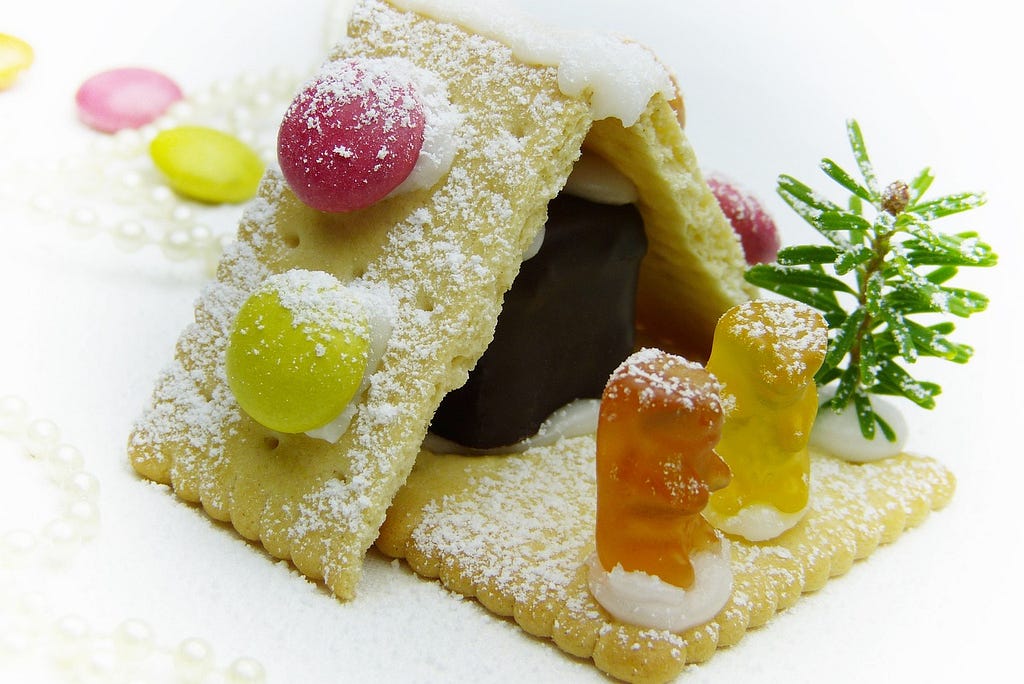 Crackers with gummy bears and candies sprinkled with powdered sugar.