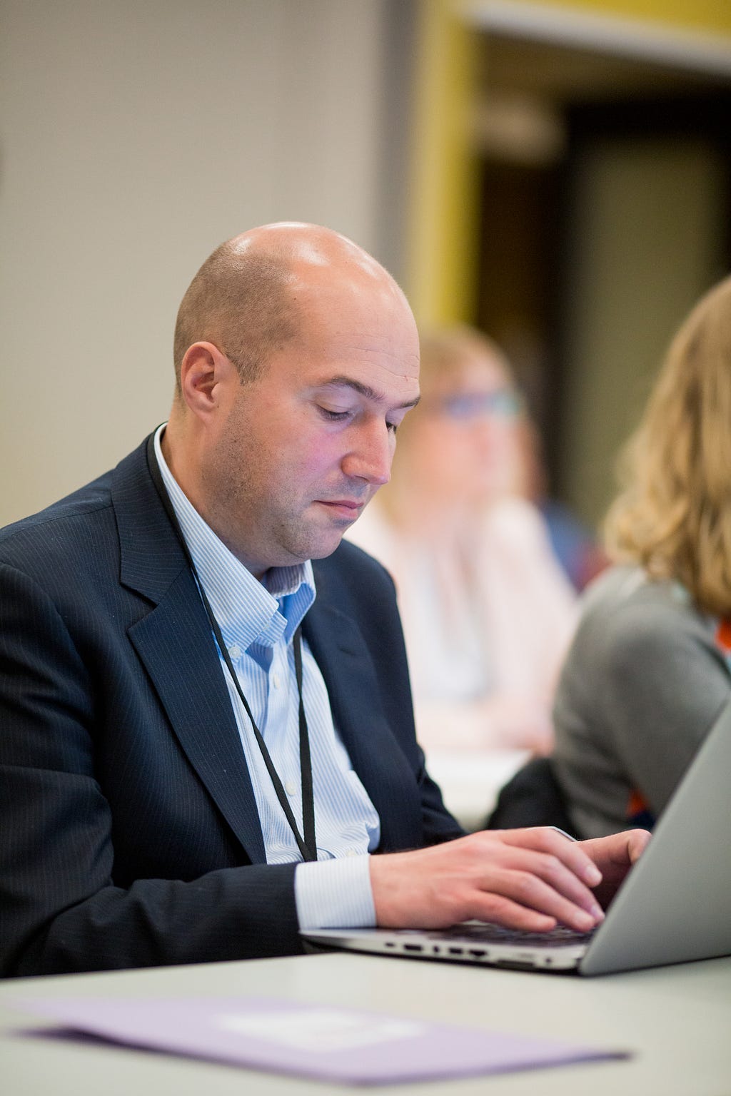 Member Christophe typing at a computer during Advancing Leadership event.