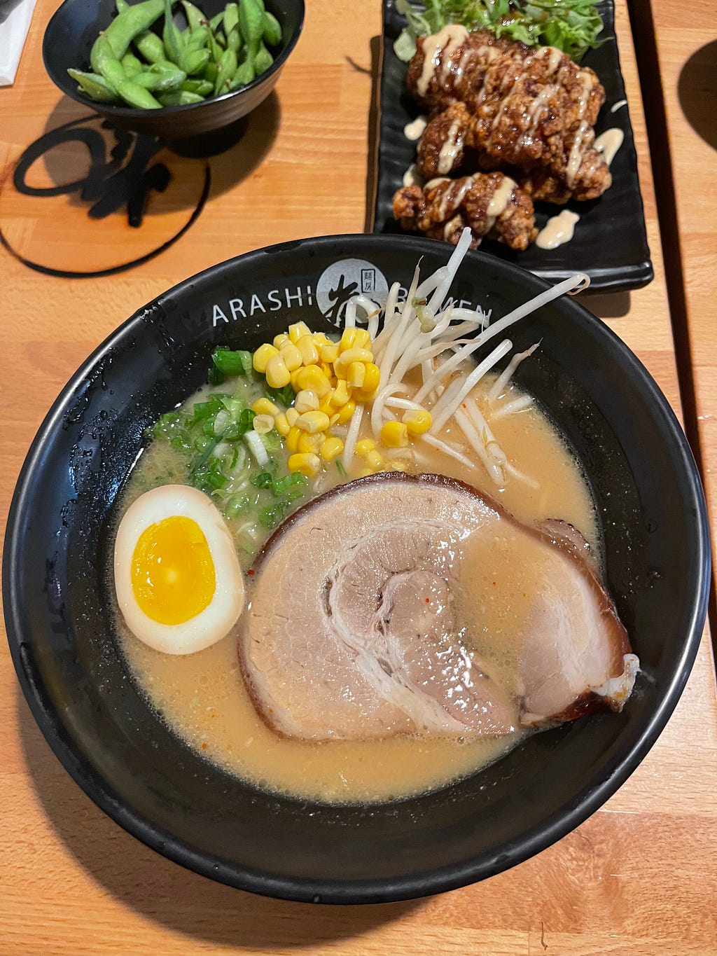 A bowl of pork broth ramen on a wooden table