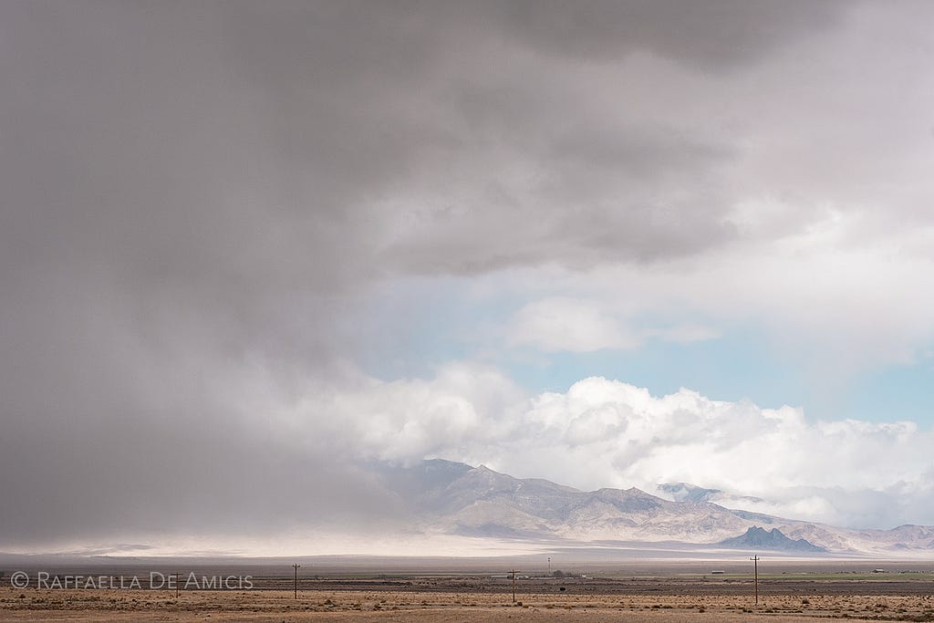 a storm blows across the desolate landscape in Nevada on the loneliest highway