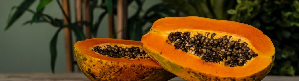 Fresh cut papaya cut in two with the black seeds intact.