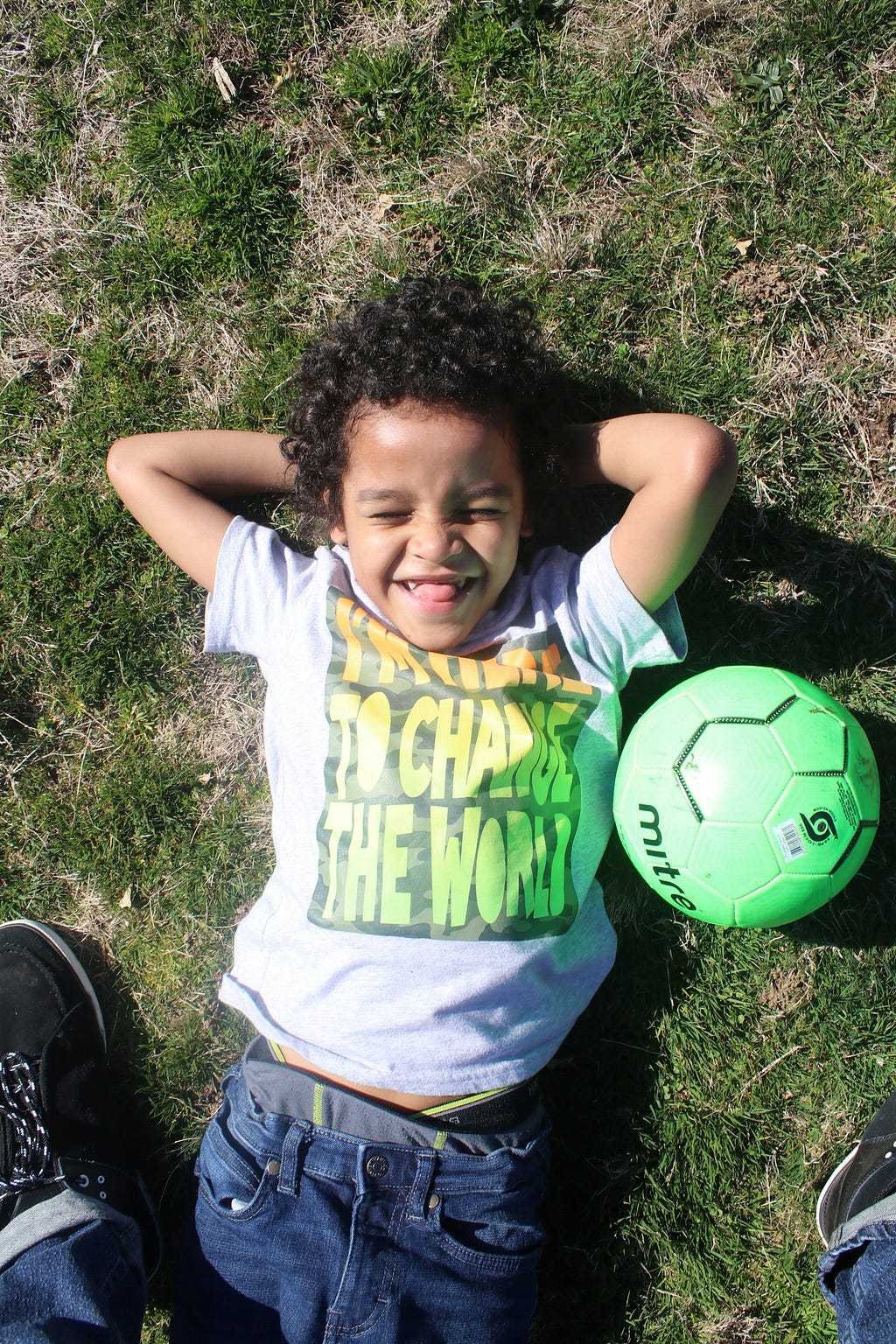 A smiling kid with a soccer ball
