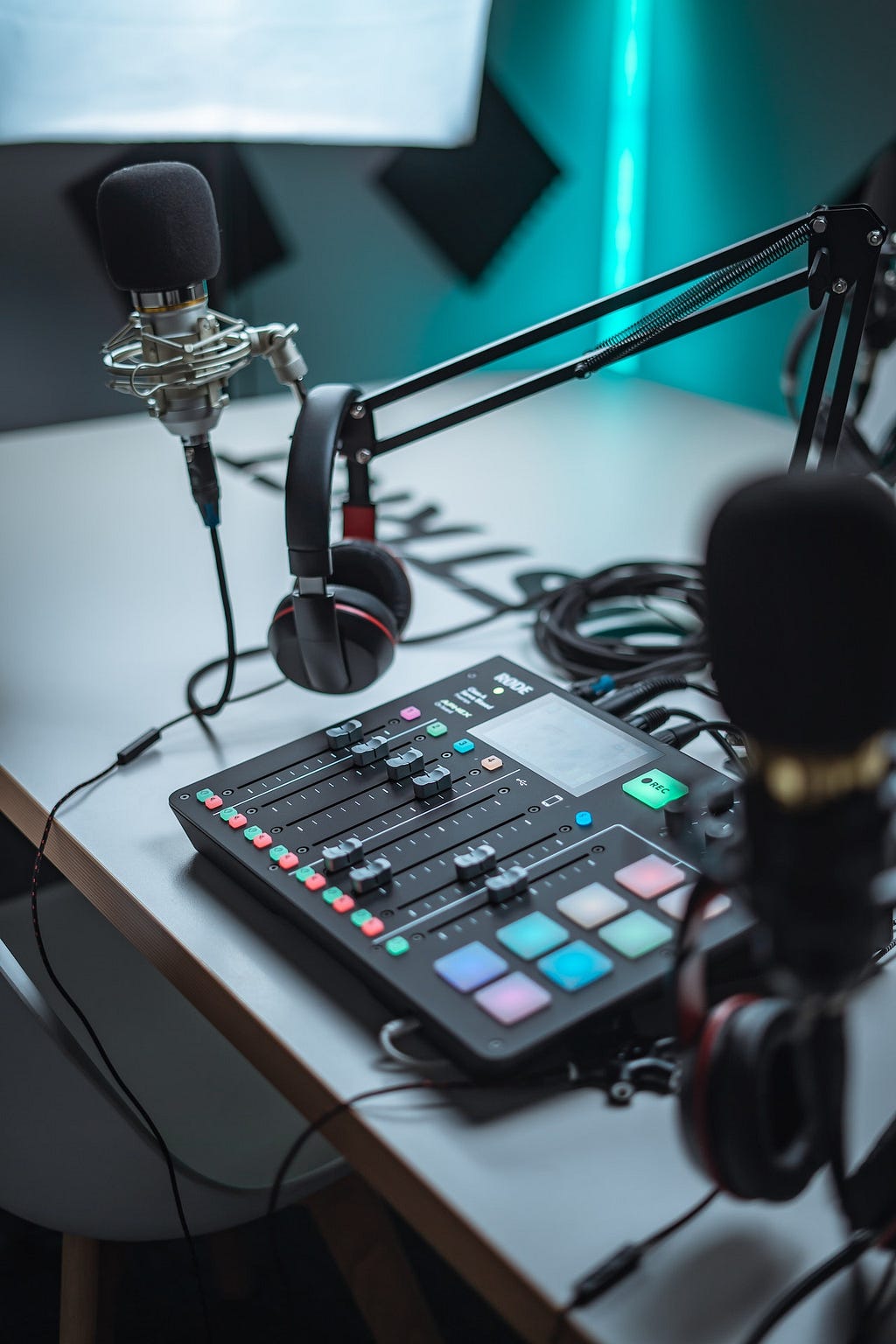 A podcast set-up with the Rode Procaster pro, headphones and a microphone