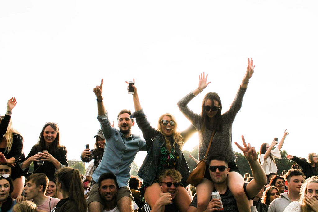 Kids cheering at a concert