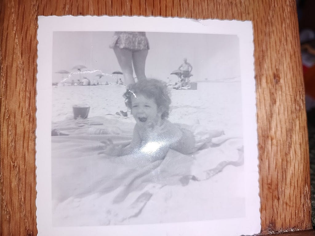 a picture of mini-me, about 20 mos old, relaxing on the sand Fire Island, NY