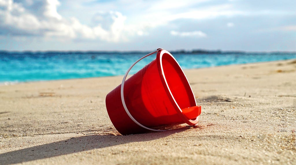 A bucket on a beach