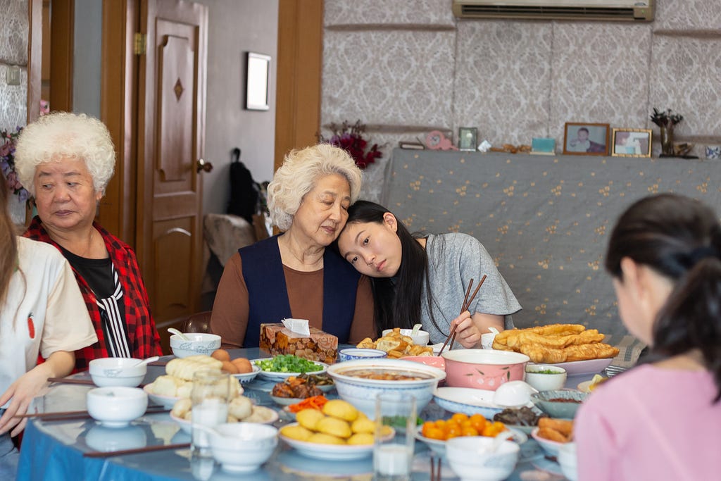 A scene from The Farewell: Billi leans on her Nai-nai’s shoulder.