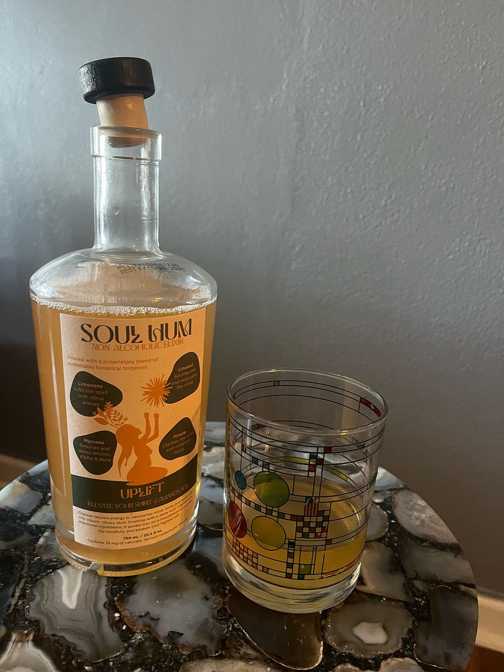 Photograph of Soul Hum Elixir bottle and glass with soulhum