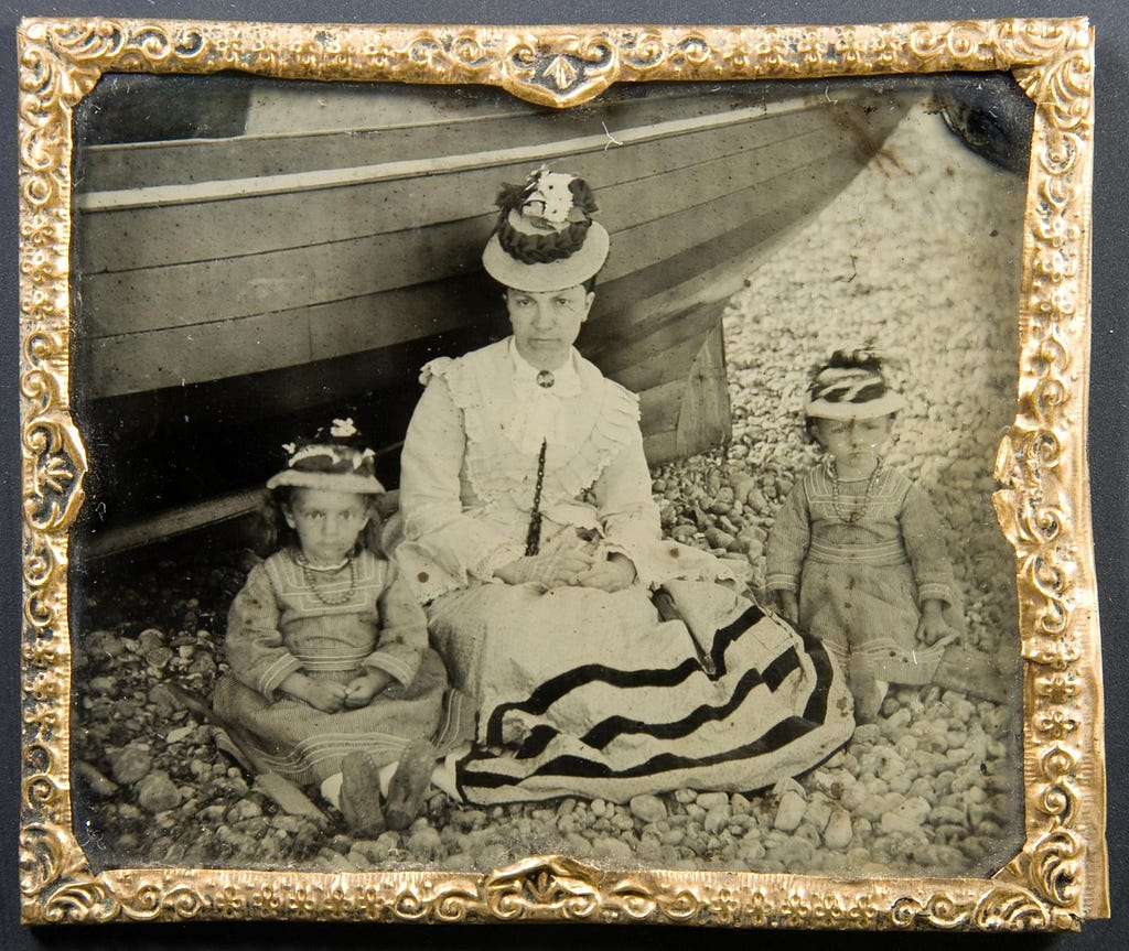 An ambrotype of a mother and her two children on the beach in the 1870's