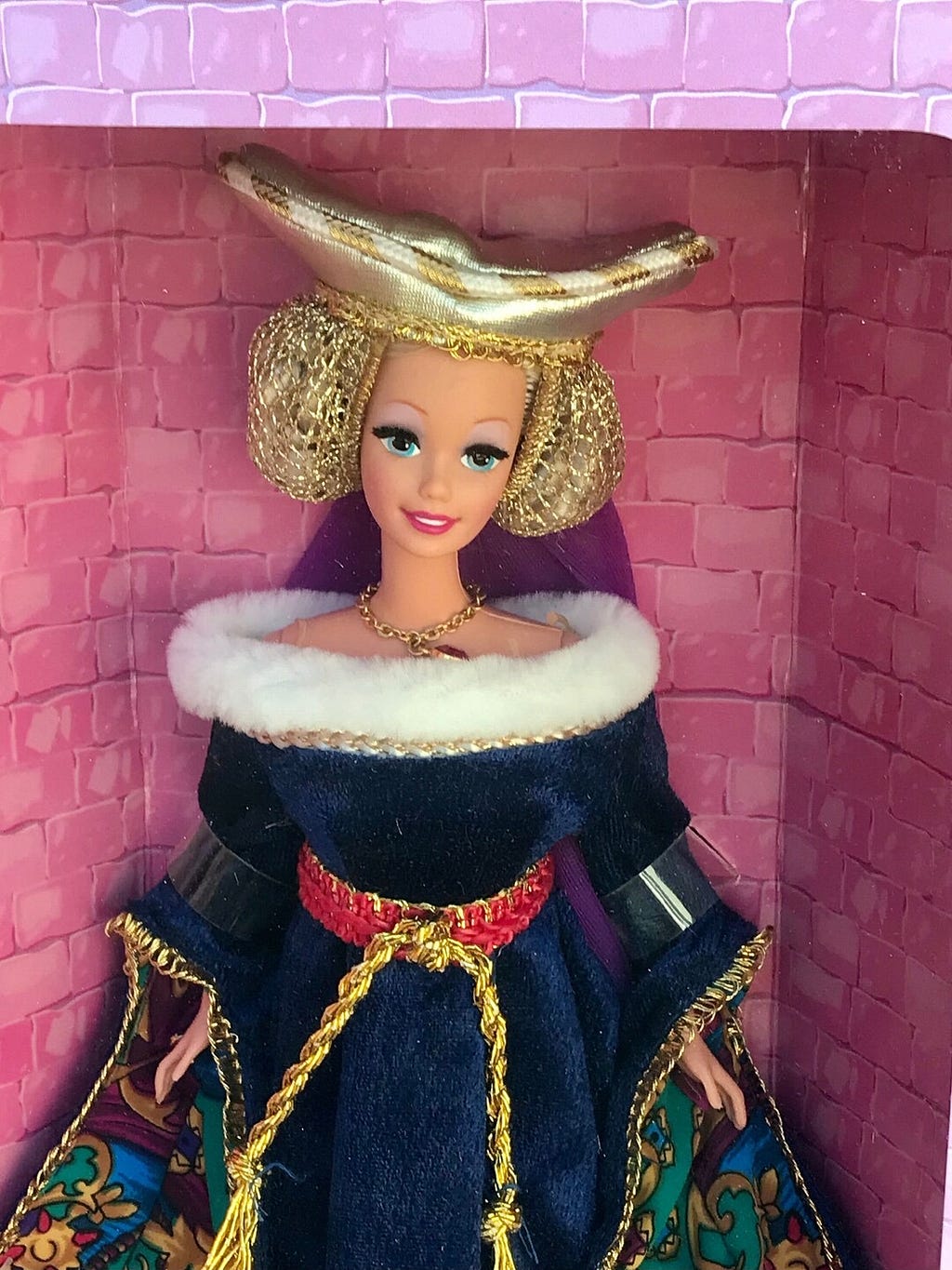 Mattel’s Medieval Barbie dressed in fur-lined blue velvet gown and gold escoffian headdress.