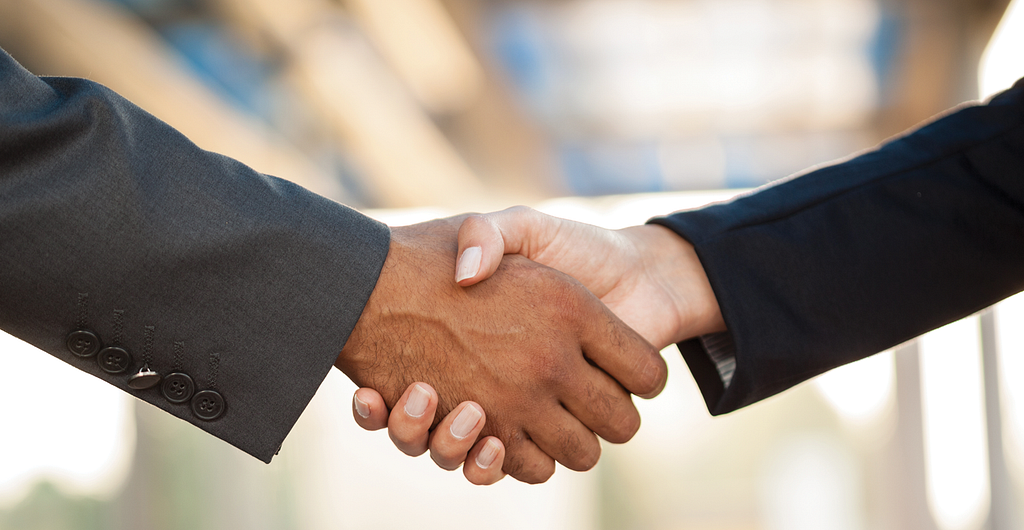 Photo of two people shaking hands.