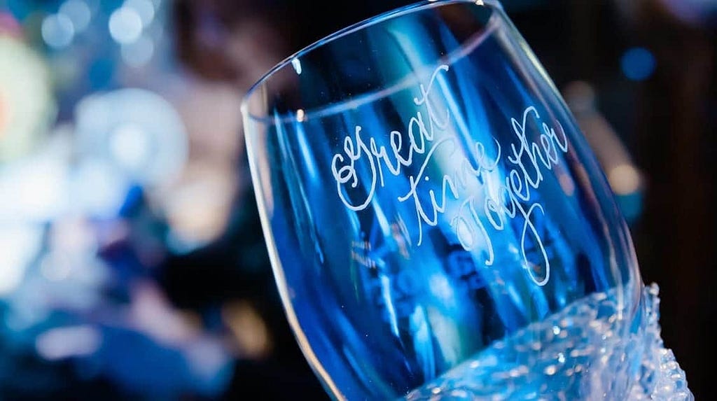 Custom engraved wine glasses make both a great experience and some of the best company swag ideas for holiday parties and gala style events. This one was engraved with “Great Time Together”