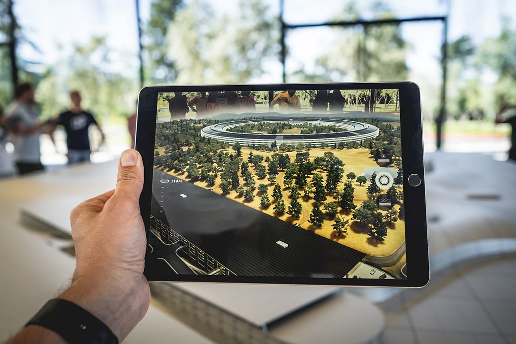 An iPad showing a 3D model of Apple’s campus using augmented reality.