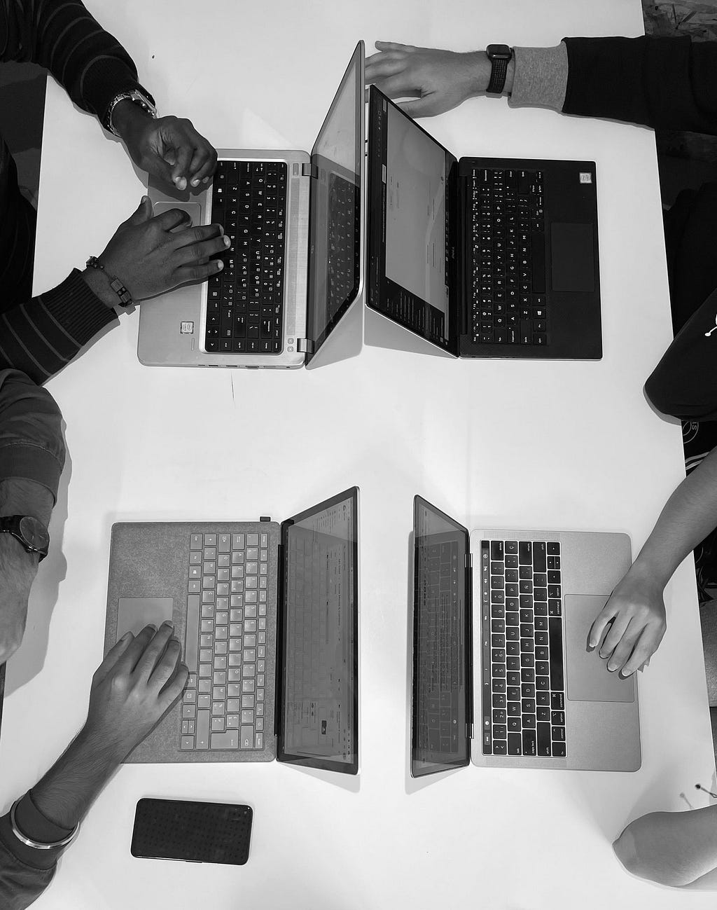 A picture showing a group of collabrators using laptops