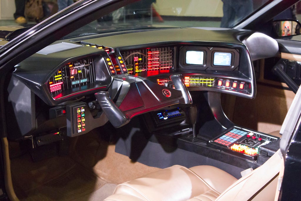 A picture showing the inside of a car, equipped with a range of electronic and intelligent devices.