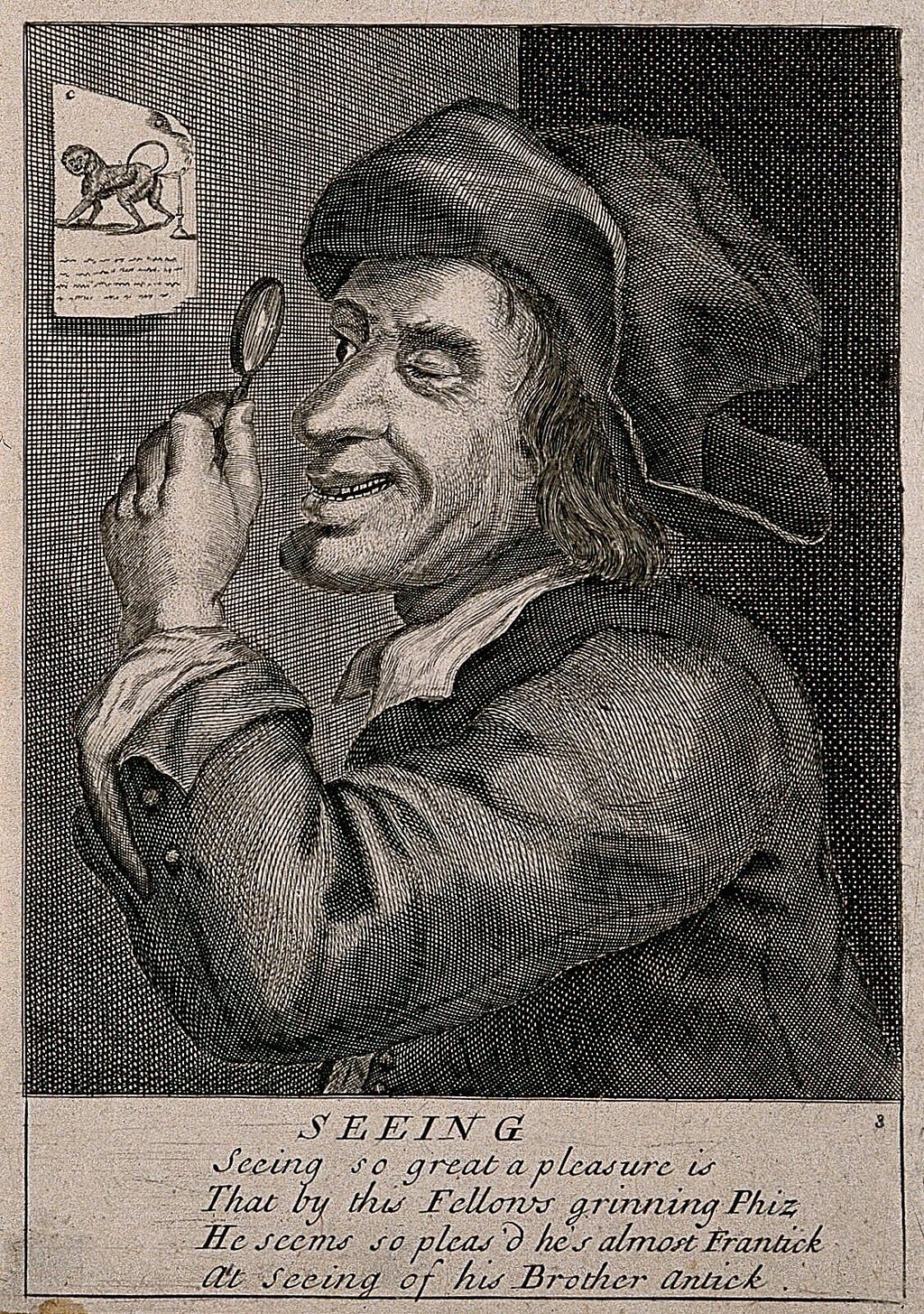 An etching of a man looking through a magnifying glass at a picture of a monkey, whose flatulence extinguishes the flame of a candle. There is text at the bottom of the page “SEEING Seeing so great a pleasure is That by this Fellows grinning Phiz He seems so pleas’d he’s almost Frantic at seeing of his Brother antic.”