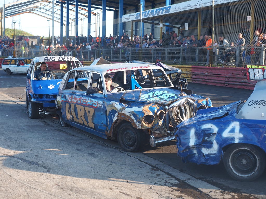 photo of bashed up stock car racing cars