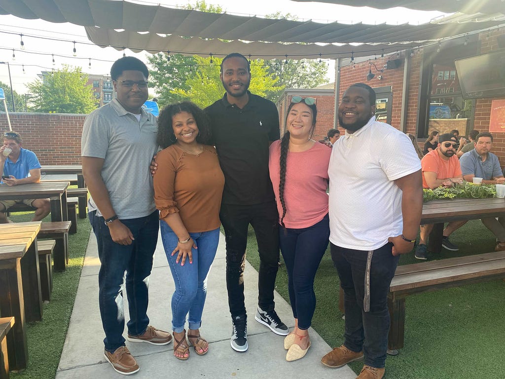 The CDL U 2021 cohort smiling for a group photo at an outdoor CDL get-together. From left to right: La Von, Lamone, Paulos, Shiana, and Brandon.