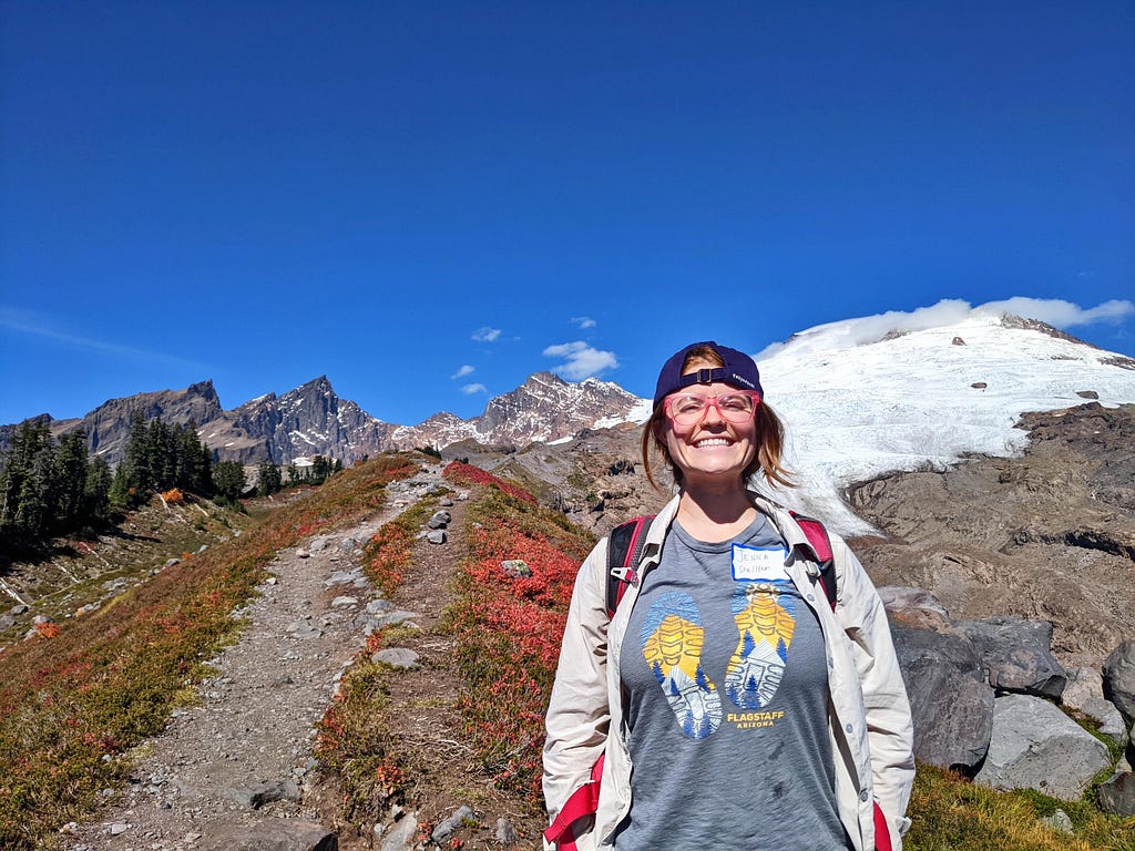 Jenna Chaffeur smiles on a mountain trail on a sunny day.