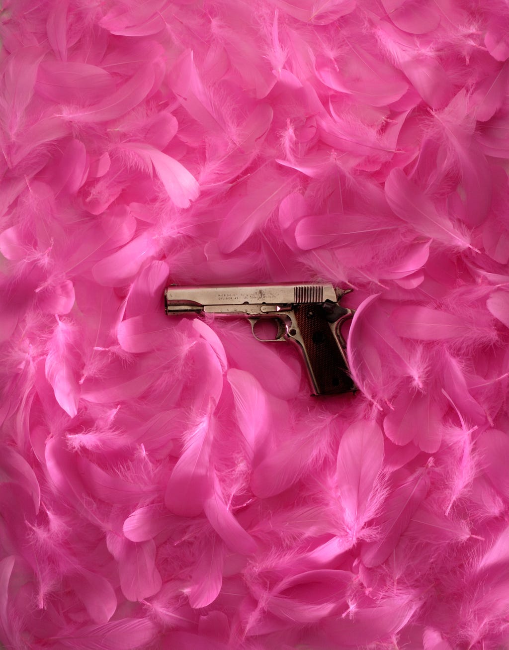 Colt 45 Pistol lying on Pink Flowers