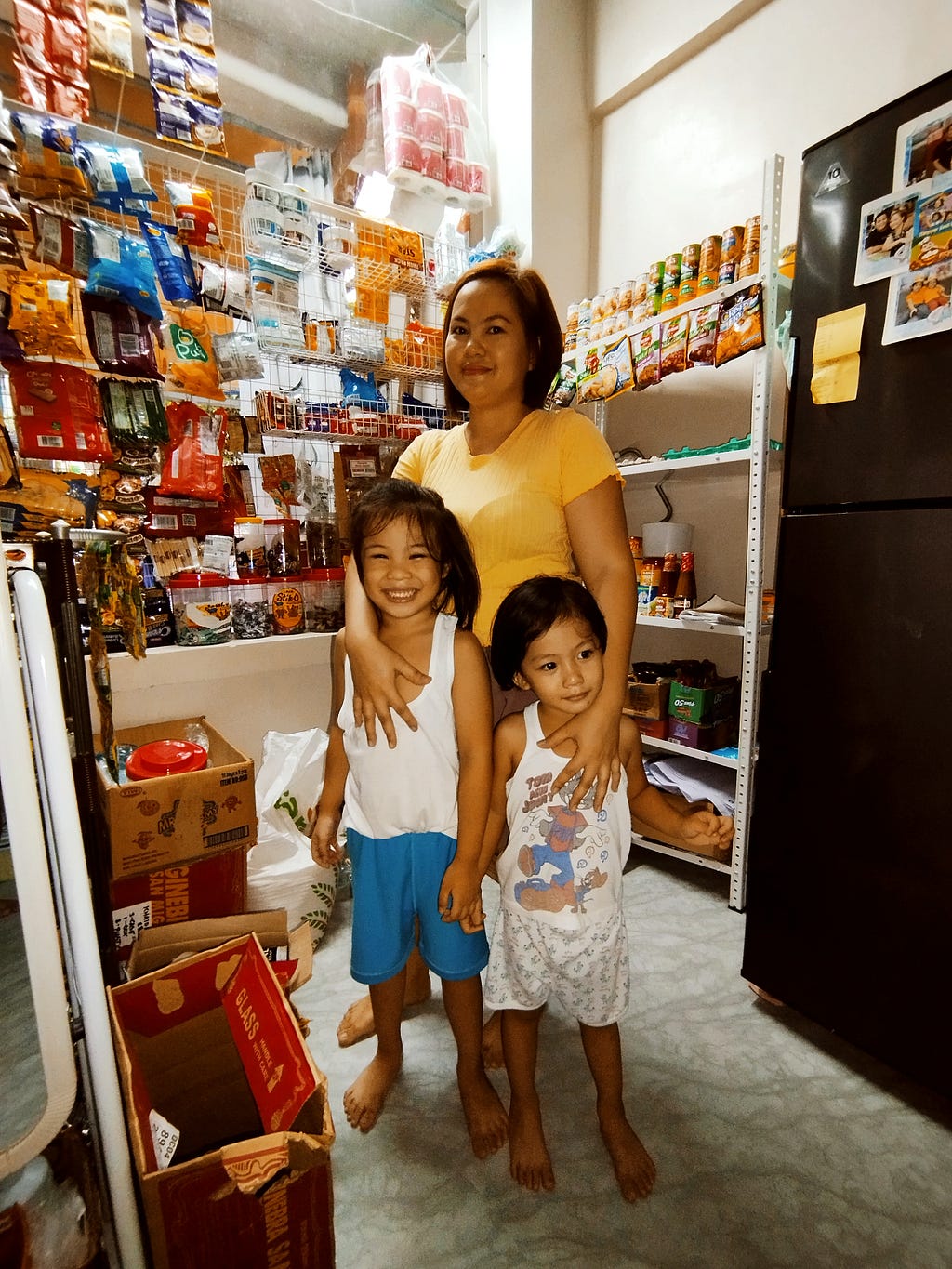 A picture of Jean Basco and her two children at her store in Manila
