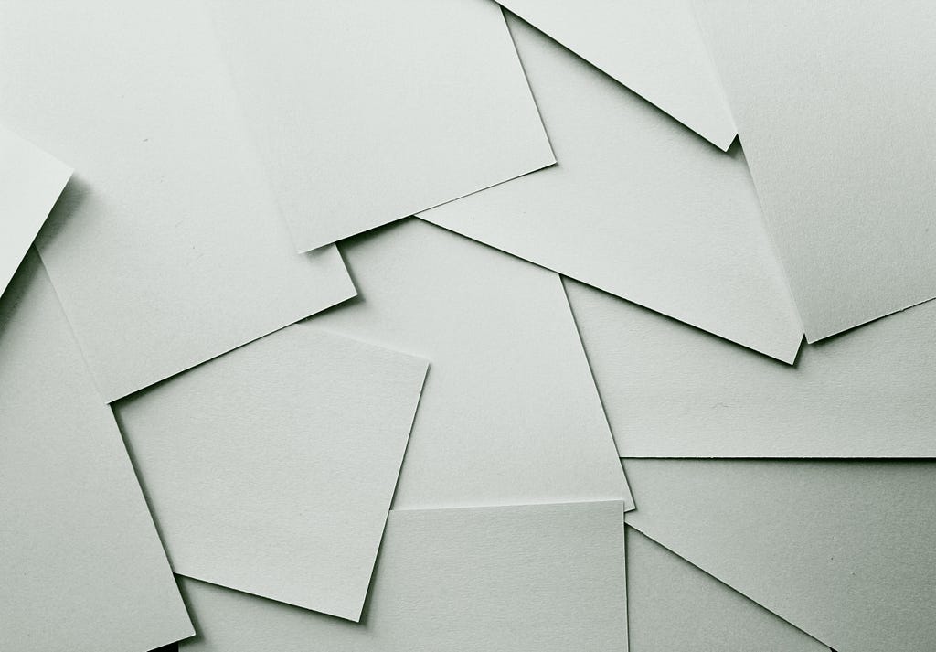 Several sheets of blank paper scatted in a pile.