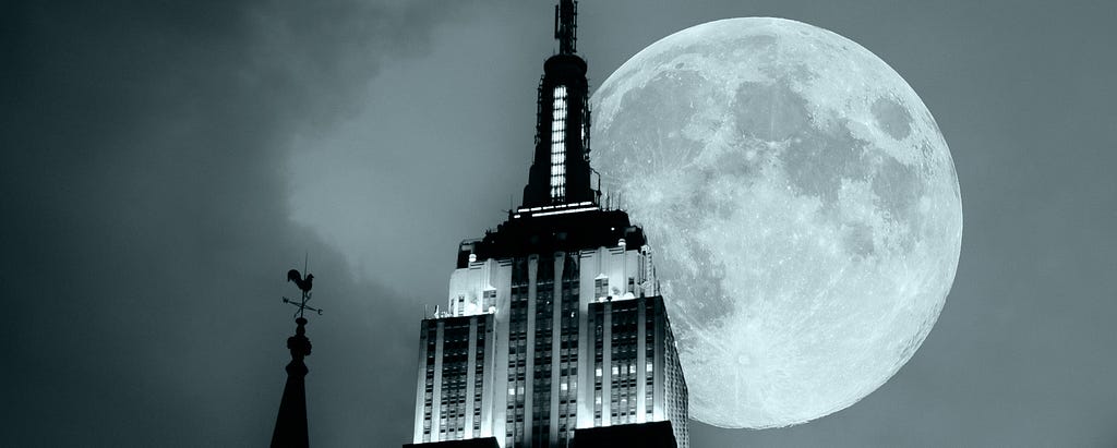 An image of the Empire State Building with a full moon in the background.