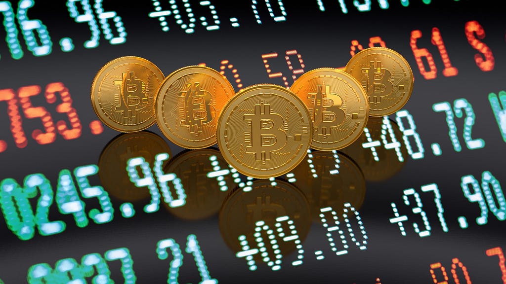 Five physical Bitcoins in a V formation hovering over a digital screen with asset prices
