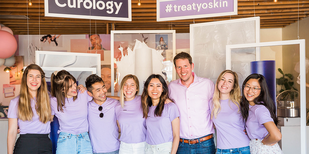 The Curology team celebrates at a skincare product launch